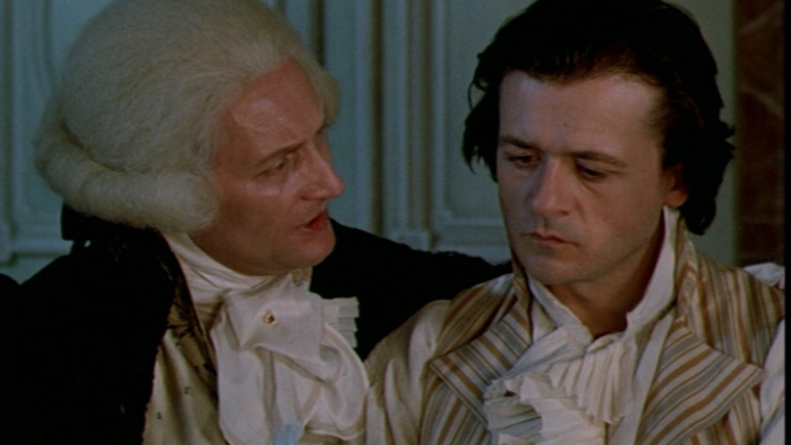 Maximilen Robespierre (Wojciech Pszoniak) hugs Camille Desmoulins (Patrice Chéreu) in the film Danton.